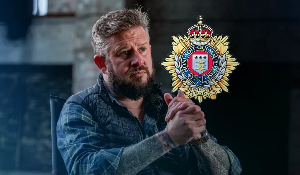 Kim Hughes sitting in an interview setting with a British Army insignia displayed beside him.