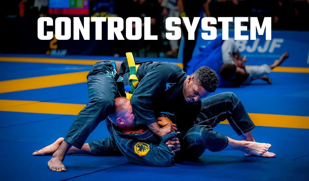 Two BJJ competitors grappling on a blue mat at an IBJJF tournament with Control System text overlay.