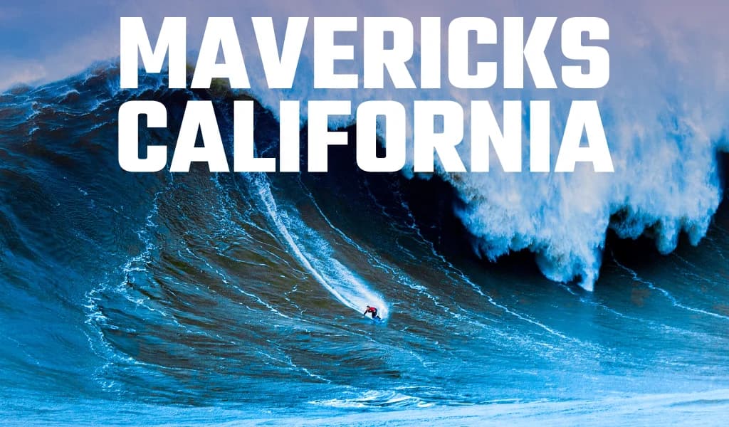 A surfer carves down a massive wave at Mavericks, California, with whitewater crashing behind him.
